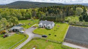 an aerial view of a large house with a garage at Drumlochy B&B in Inverness