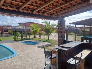 a patio with a bar and a swimming pool at Casa Cantinho do Céu Santo Amaro MA in Santo Amaro