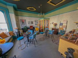 a room with chairs and tables in a room at The Sheldon B&B in Eastbourne
