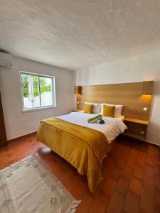 a bedroom with a large bed and a window at Villa Valentina-Sunny 2 Bedroom House with Pool in Carvoeiro