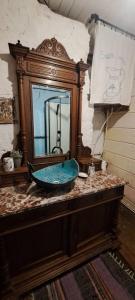 a bathroom with a sink and a mirror on a counter at Józefowa Chata in Rudnik
