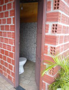 a bathroom with a toilet in a brick wall at Casa Cantinho do Céu Santo Amaro MA in Santo Amaro +8 photos