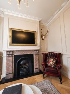 a living room with a fireplace with a television above it at NO 60 Sligo in Sligo