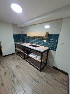 a kitchen with a counter and blue tile at Hotel casa el Palomar -5 in San Baltasar
