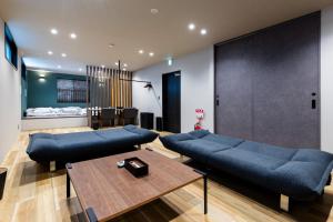 a living room with two blue couches and a table at 2F, 3F - Vacation STAY 20122v in Sumiyoshi