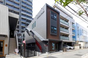 a building with a spiral staircase in front of a building at 2F, 3F - Vacation STAY 20122v in Sumiyoshi