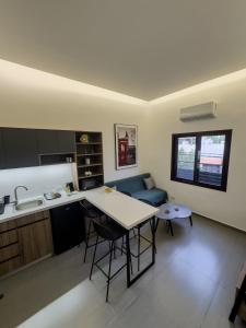 a kitchen and living room with a table and a couch at Railway studio 3 - Luxury Suite in Byblos - Central & Relaxing in Jbeil