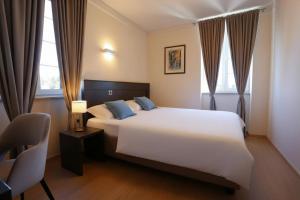 a bedroom with a large white bed with blue pillows at Villa Hrešć I in Zadar +64 photos