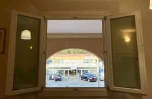 an open window with a view of a parking lot at Arcadia Hosting Aeroporto in Bologna