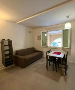 a living room with a couch and a table at Arcadia Hosting Aeroporto in Bologna