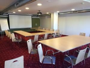 a classroom with tables and chairs and a whiteboard at Kutscherwirt in Vorau