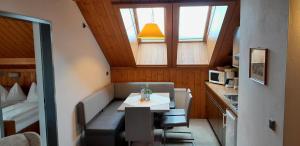 a small room with a small table and a kitchen at Ferienhof Alte Post in Weissbriach