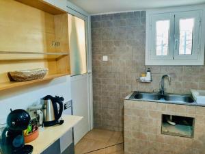 a kitchen with a sink and a counter top at Seafront Villa, Fay in Kardamyli