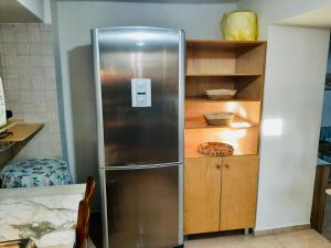 a stainless steel refrigerator in a kitchen at Seafront Villa, Fay in Kardamyli