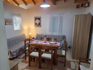 a living room with a table and a couch at Seafront Villa, Fay in Kardamyli