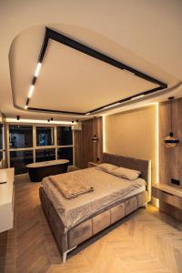 a bedroom with a large bed in a room at AMD LUX apartman in Bijeljina