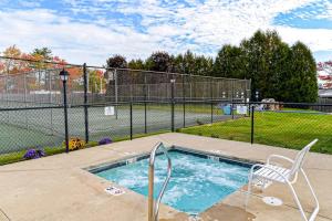 a swimming pool with a chair next to a fence at Unit 117 for Poolside Fun in Wells +13 photos