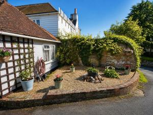 a garden in front of a house with potted plants at The Beaumont in Sittingbourne