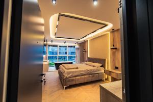 a bedroom with a bed and a large mirror at AMD LUX apartman in Bijeljina