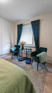 a bedroom with two chairs and a table and a window at SEA - 3 Bedrooms in Kristinestad +45 photos