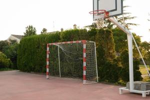 a basketball hoop with a net in a yard at Masia Olivera in Sant Pau dʼOrdal