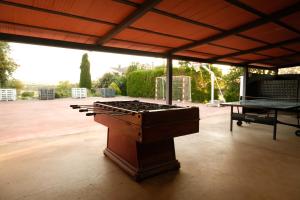a outdoor patio with a grill and a table at Masia Olivera in Sant Pau dʼOrdal
