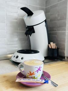 a coffee maker sitting on a counter with a cup of coffee at Apartament 29 in Orăştie +2 photos