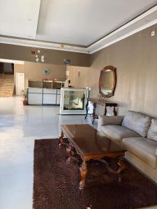 a living room with a couch and a table at Residencial Convênios- Hotelaria e Turismo LDA in Luanda