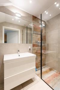 a bathroom with a white sink and a shower at Apartament z Liskiem Szczyrk przy Żylicy SKI bus narty relaks i natura in Szczyrk +15 photos