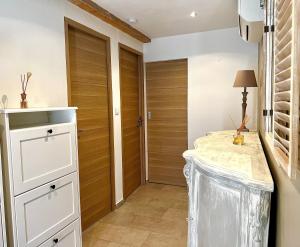 a kitchen with a counter and a hallway with wooden doors at Maison plein pied in Sorgues