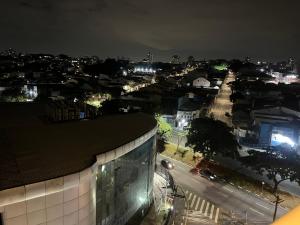 a view of a city at night with a building at Flat 701 in Guarulhos