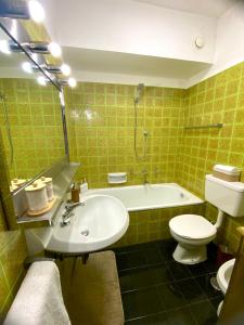 a bathroom with a tub and a sink and a toilet at Pescasseroli Home in Pescasseroli +26 photos