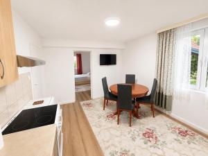 a kitchen and dining room with a table and chairs at Little Farm Nani in Visoko