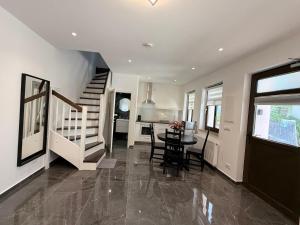 a kitchen and dining room with a table and stairs at Apartmenthaus Döbeln Zentrum 01 in Döbeln