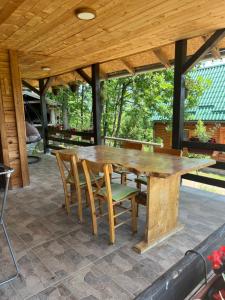 a wooden table and chairs on a patio at Brvnare Dunja 1 i Dunja 2 in Kraljevo