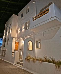 a white house with a staircase on the side of it at BLUE IN NAXOS in Naxos Chora