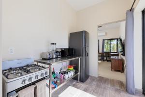 a kitchen with a stove and a refrigerator at Ocean View Studio Near Los Barriles in Buenavista +42 photos