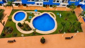 an overhead view of a large swimming pool in a resort at Spacious Family Apartment - Air Conditioning, Pool & Garden Views in Martil +25 photos