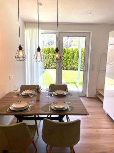 a dining room with a wooden table and chairs at Apart Alma in Pfunds