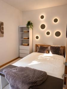 a bedroom with a large white bed with areath on it at Wellspace Forest Retreat in Karlovy Vary +13 photos