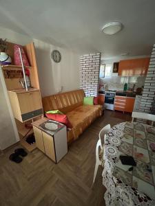 a living room with a couch and a table at Tri Cveta in Popadić +2 photos