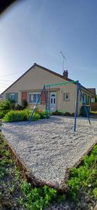 a swing set in front of a house at Le Cat'Etoiles in Autun