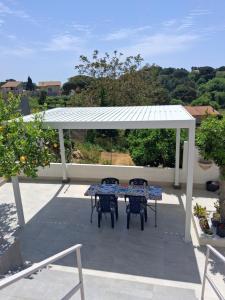 a patio with a table and chairs under a pavilion at A Casuzza in Salemi