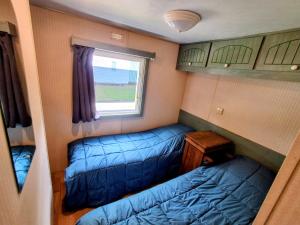a small room with two beds and a window at Evasion Charente in Sémussac