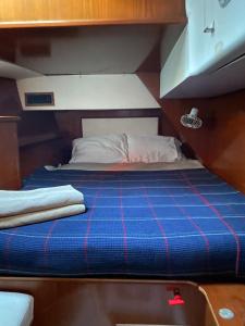 a bed in a small room on a boat at Каюта in Kotor