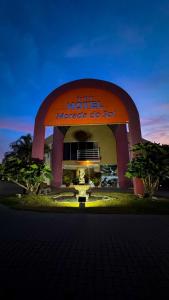 a hotel with a sign in front of a building at Hotel Morada do Sol in Chavantina