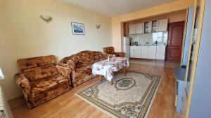 a living room with a couch and a table at Guest House Byki in Sveti Vlas