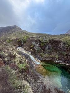 a pool of water on the side of a mountain at Laimhrig Lockley in Torrin +2 photos
