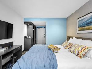 a hotel room with a large bed and a flat screen tv at ibis Styles Paignton in Paignton +66 photos