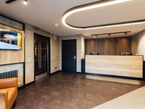 a lobby with a waiting room with a tv at ibis Coleraine Riverside in Coleraine